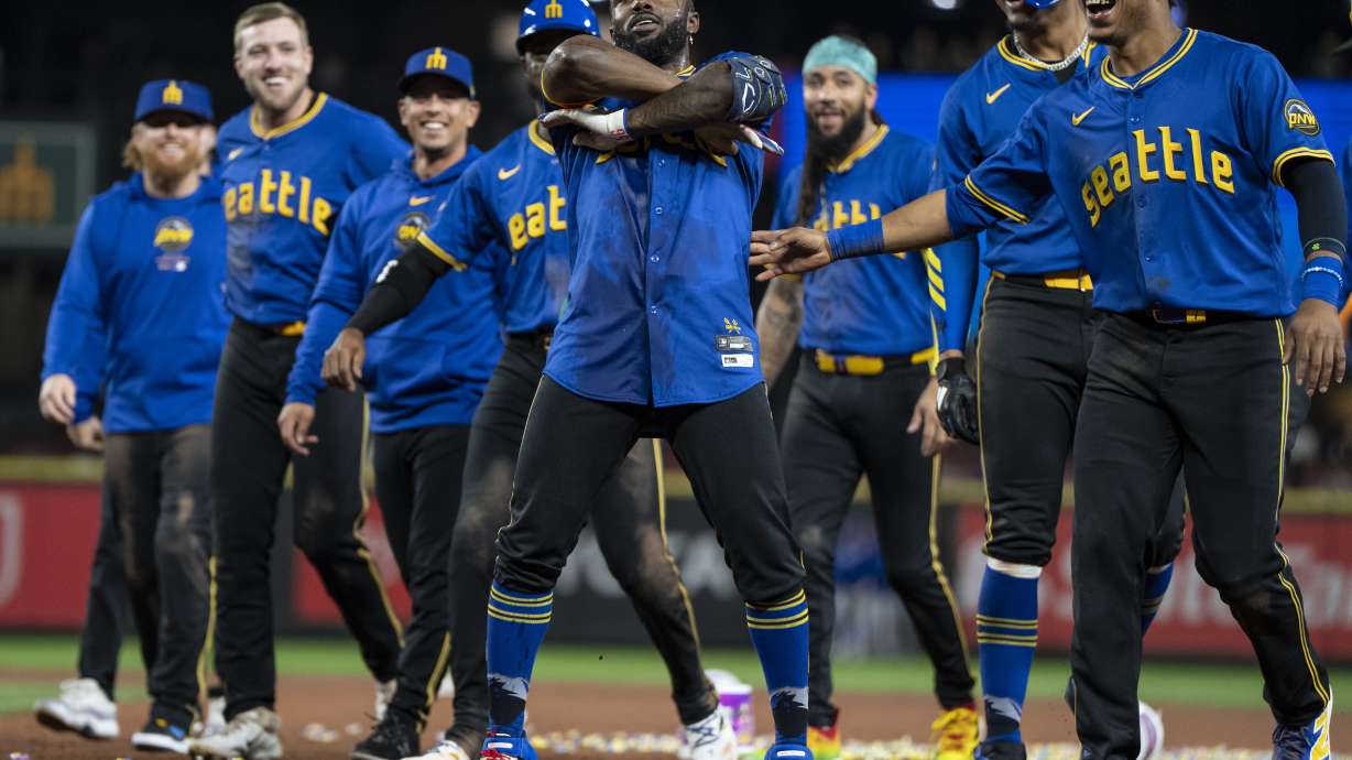 Seattle Mariners' Randy Arozarena, center, celebrates with teammates including Jorge Polanco, far right, and Julio Rodriguez, second from right, after a baseball game against the Texas Rangers, Saturday, Sept. 14, 2024, in Seattle.