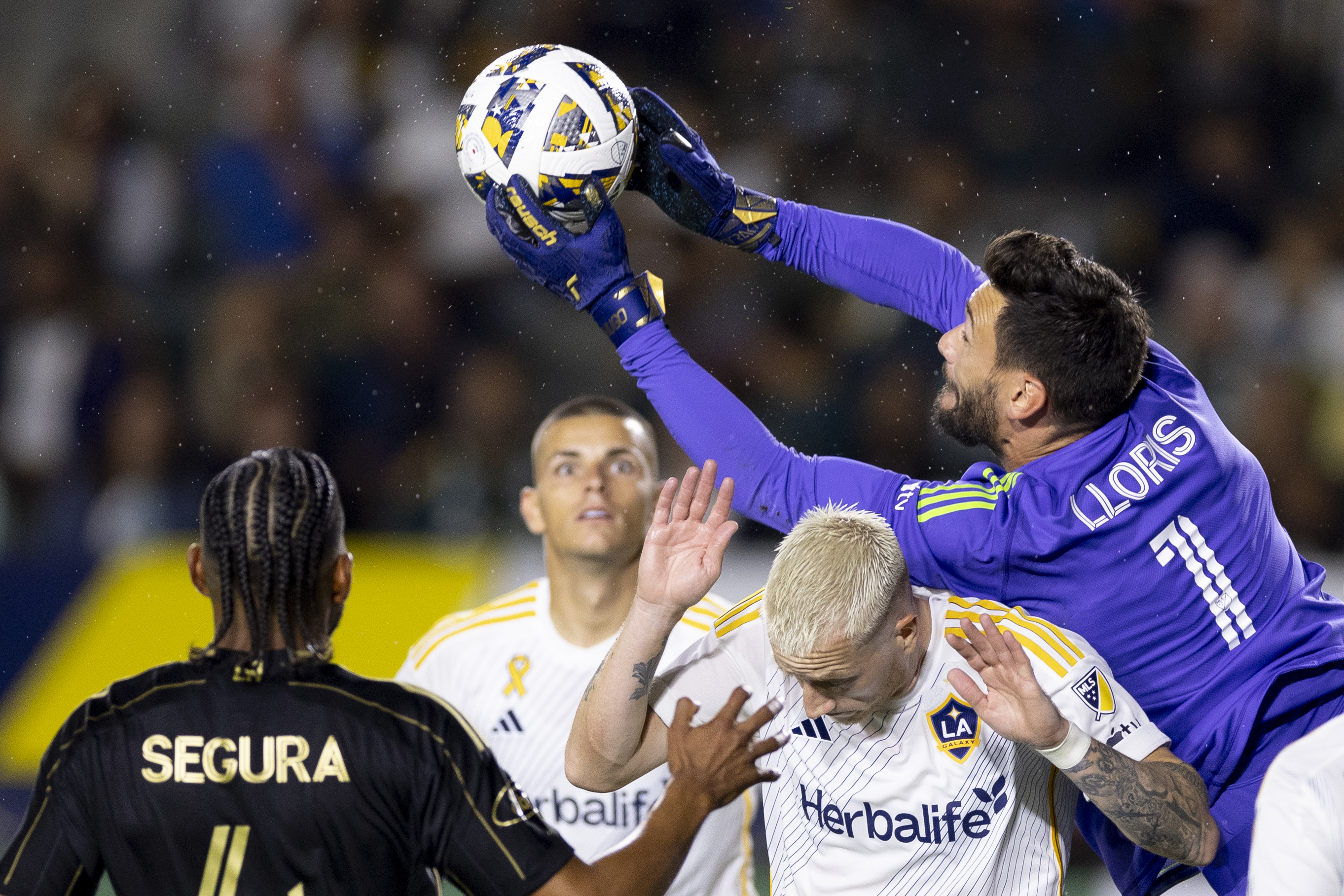 Los Angeles FC goalkeeper Hugo Lloris, right, saves a shot above Los Angeles Galaxy forward Marco Reus, second from left, during the first half of an MLS soccer match, Saturday, Sept. 14, 2024, in Carson, Calif.