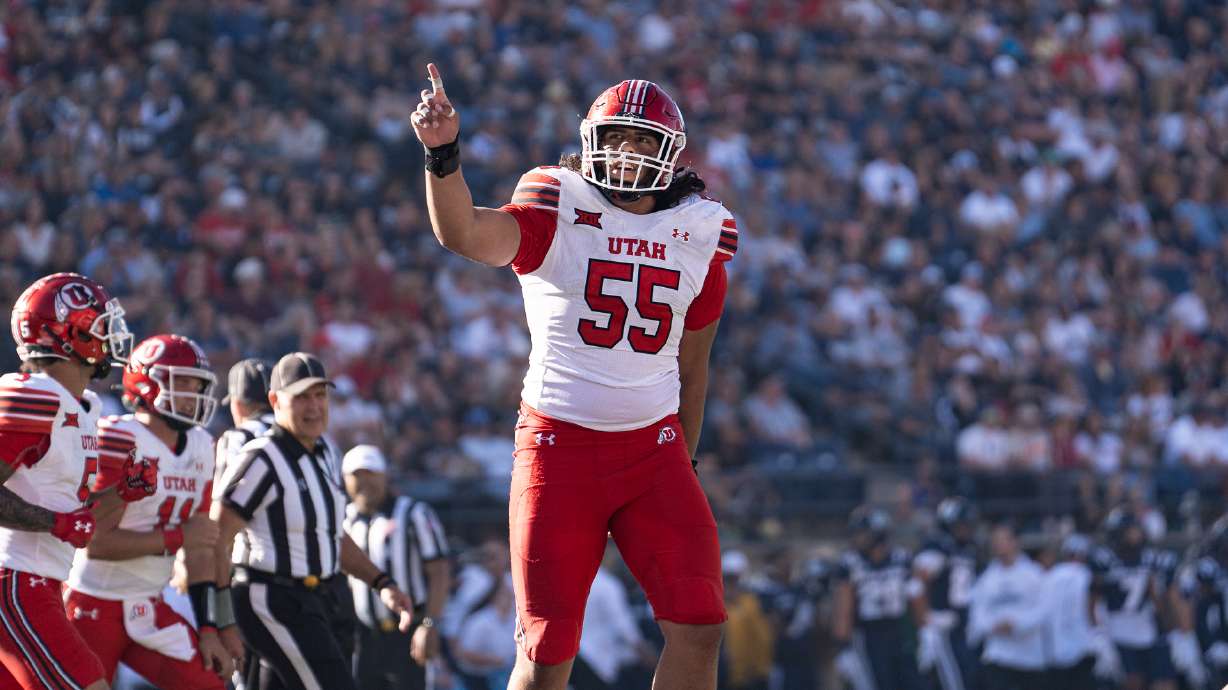 Utah offensive lineman Spencer Fano points up to the crowd in a game against Utah State at Maverik Stadium on Sept. 14, 2024.