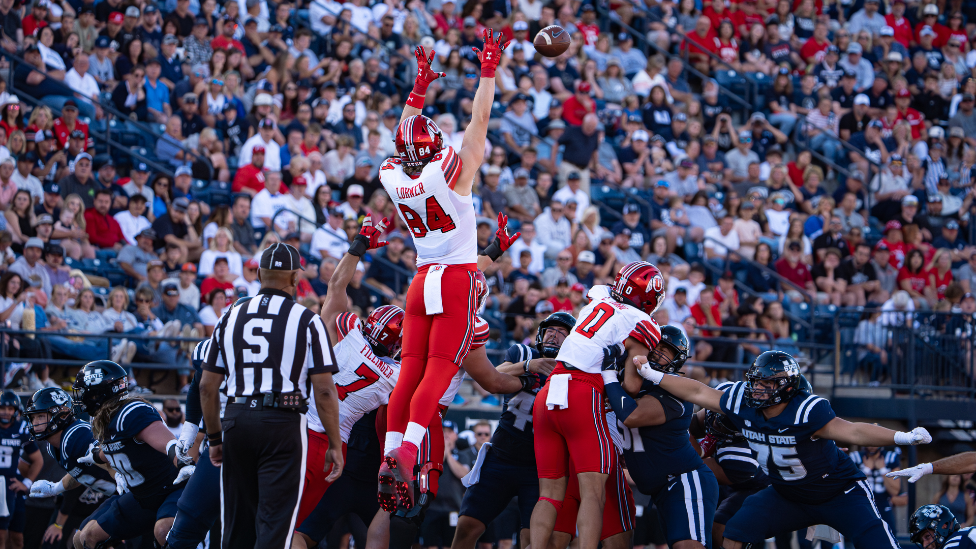 Utah tight end Caleb Lohner jumps high in an attempt to block a field goal attempt by Utah State at Maverik Stadium in Logan on Sept. 14, 2024.