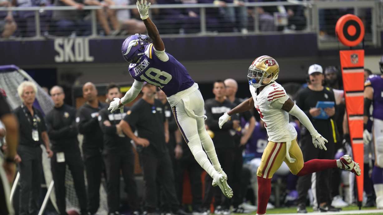 Minnesota Vikings wide receiver Justin Jefferson (18) reaches for an incomplete pass over San Francisco 49ers cornerback Deommodore Lenoir (2) during the first half of an NFL football game, Sunday, Sept. 15, 2024, in Minneapolis.