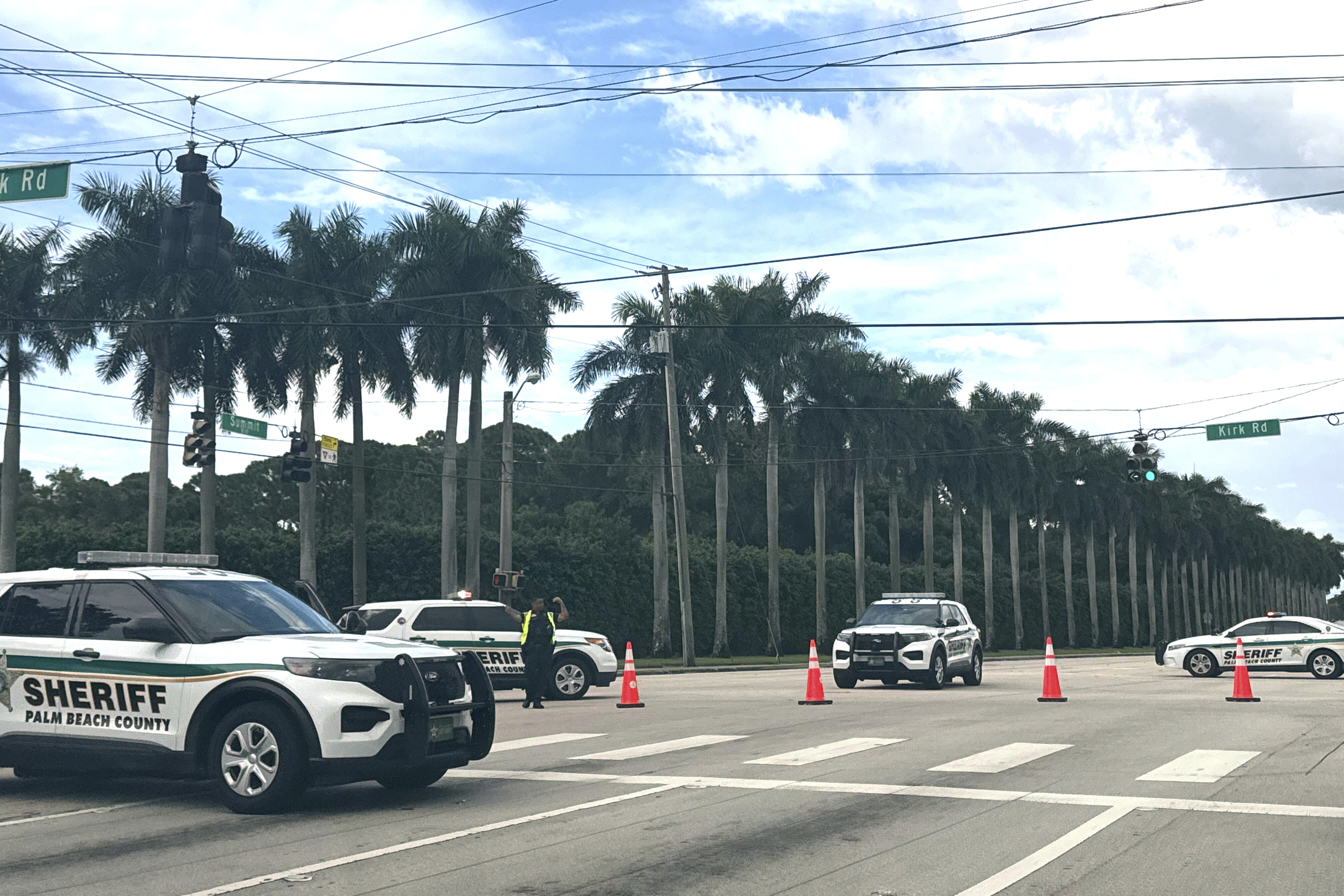 Sheriff's vehicles are pictured near Trump International Golf Club, Sunday, in West Palm Beach, Fla., after gunshots were reported in the vicinity of former President Donald Trump.