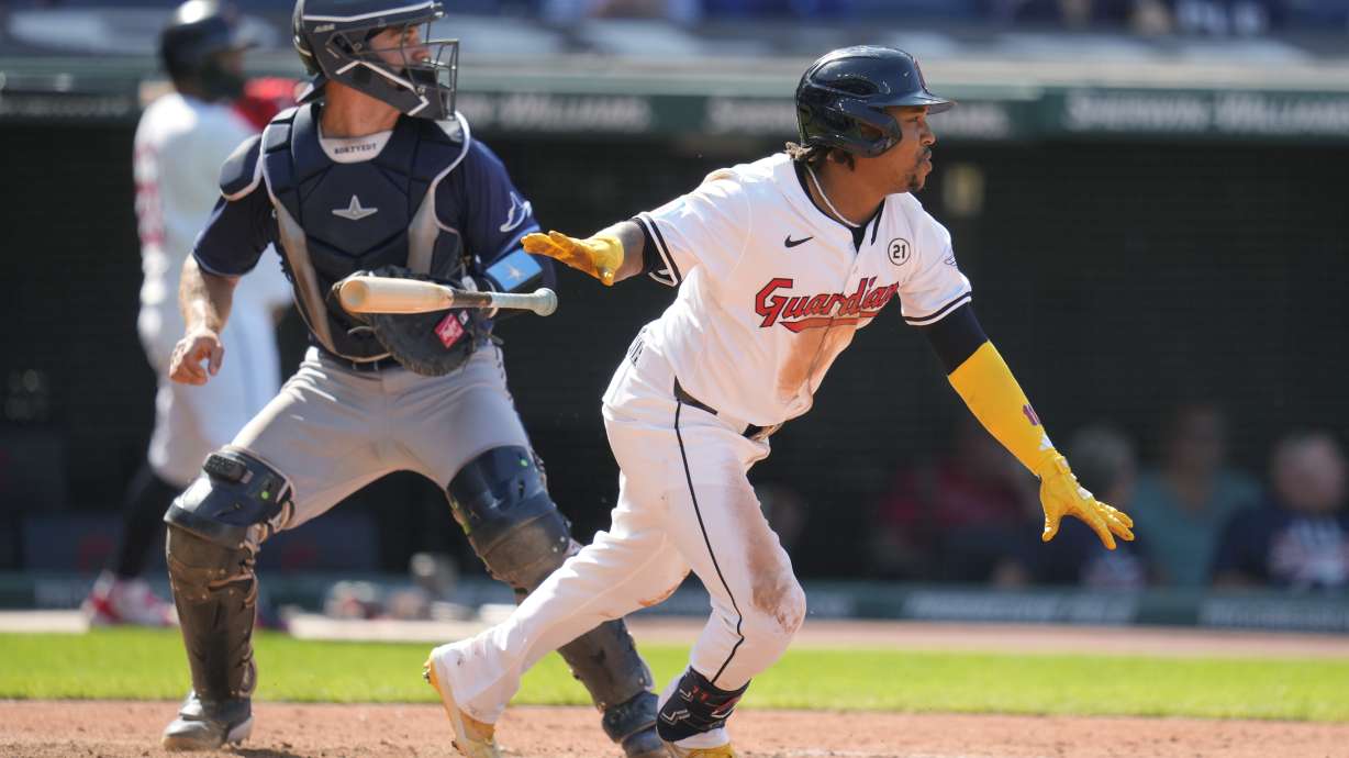 Cleveland Guardians' Jose Ramirez, right, and Tampa Bay Rays catcher Ben Rortvedt, left, watch Ramirez's single in the fifth inning of a baseball game Sunday, Sept. 15, 2024, in Cleveland.