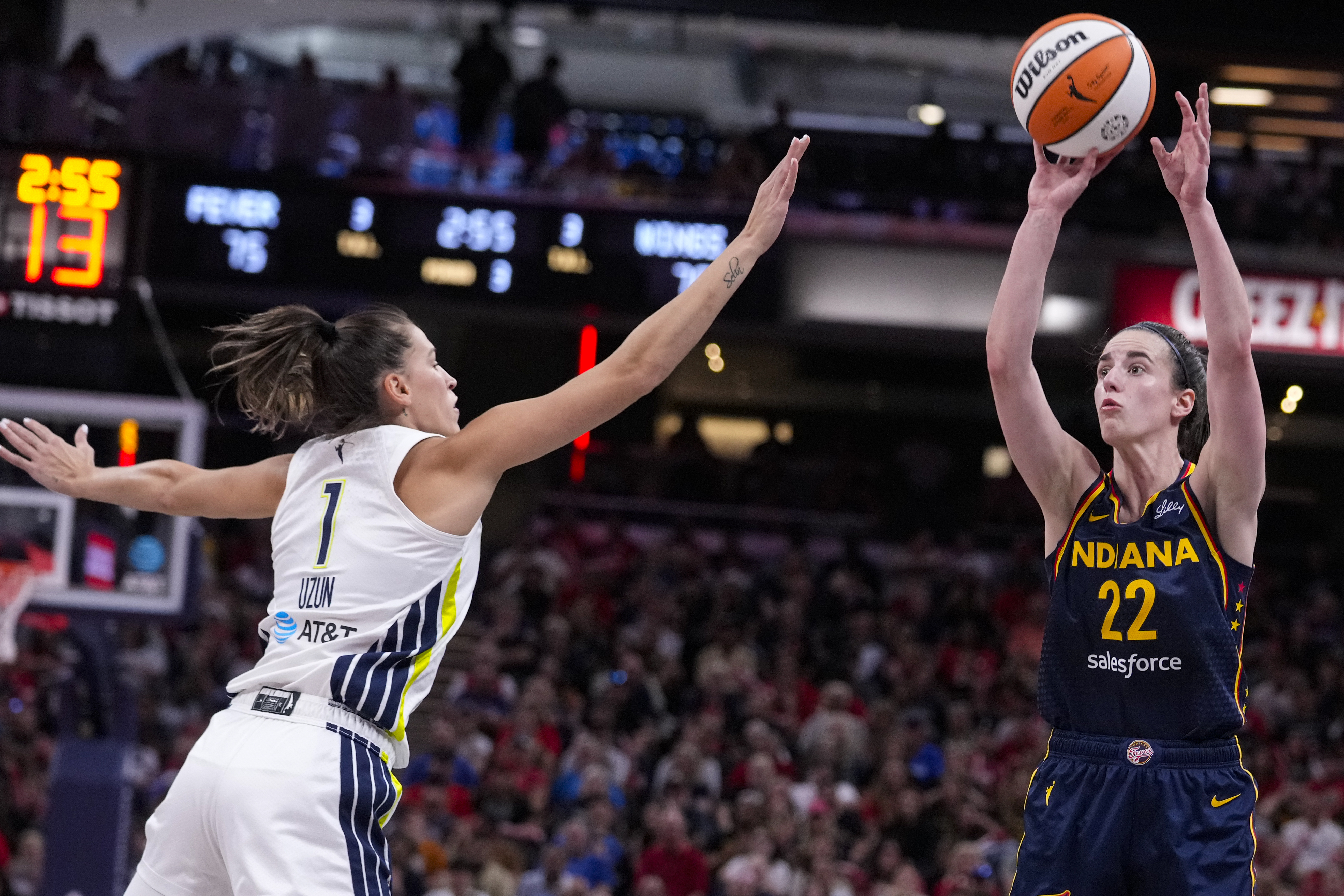 Indiana Fever guard Caitlin Clark (22) shoots over Dallas Wings guard Sevgi Uzun (1) in the second half of a WNBA basketball game in Indianapolis, Sunday, Sept. 15, 2024.