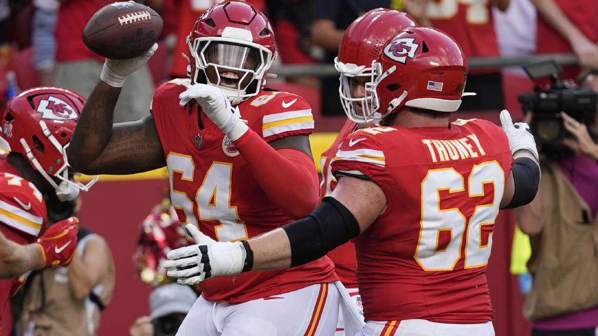 Kansas City Chiefs offensive lineman Wanya Morris, left, is congratulated by teammate Joe Thuney (62) after catching a touchdown pass during the second half of an NFL football game against the Cincinnati Bengals Sunday, Sept. 15, 2024, in Kansas City, Mo.