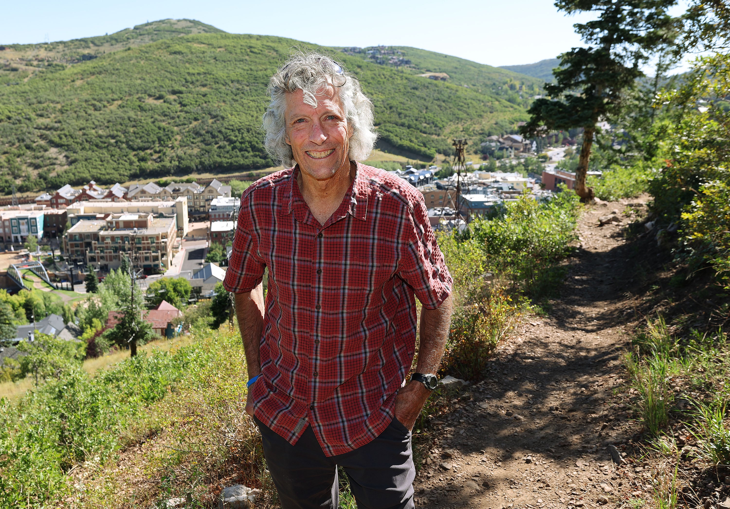 Charlie Sturgis, who has helped build the 500-plus miles of trails used by hikers, bikers and nordic skiers, stands on a trail above old town Park City on Aug. 27.