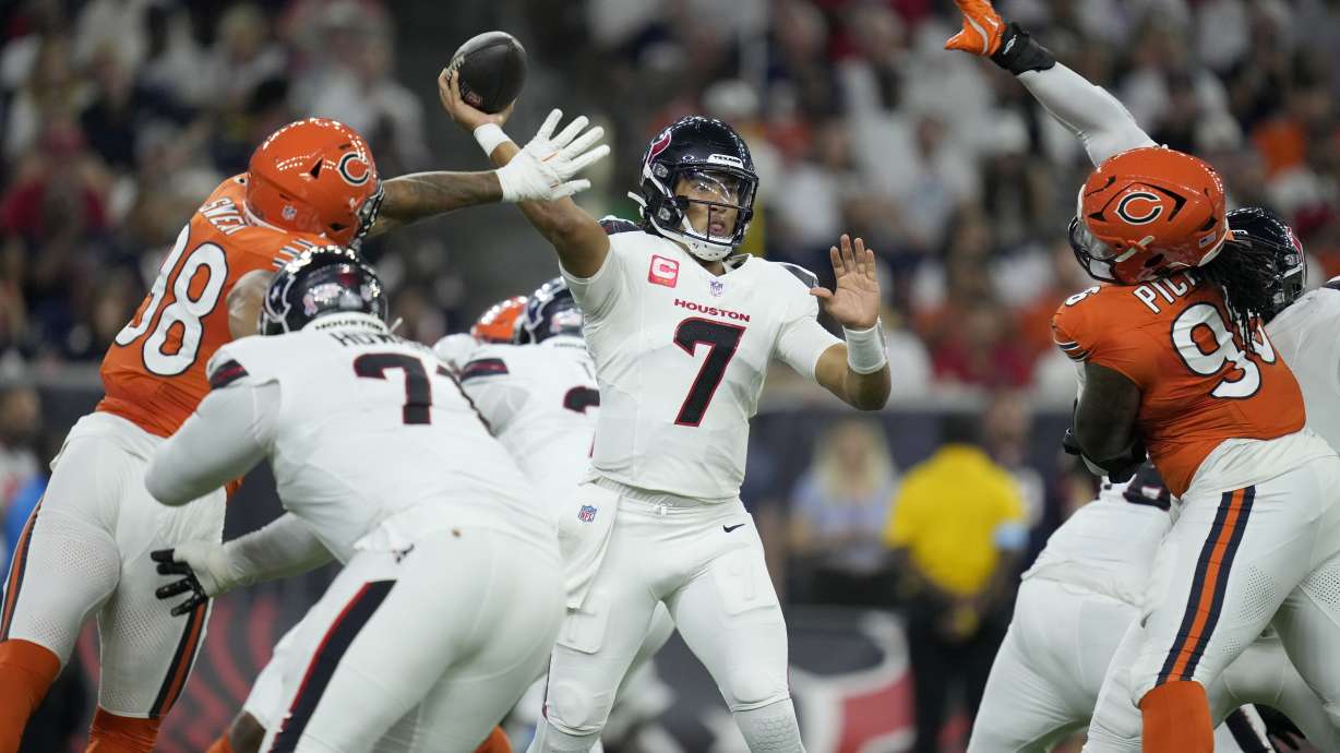 Houston Texans quarterback C.J. Stroud (7) throws under pressure from Chicago Bears defensive lineman Montez Sweat (98) and defensive lineman Zacch Pickens, right, during the first half of an NFL football game Sunday, Sept. 15, 2024, in Houston.