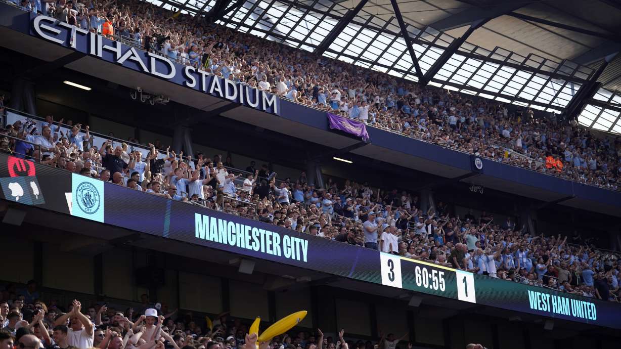 FILE - Manchester City fans celebrate after Manchester City's Rodrigo scores his side's third goal during the English Premier League soccer match between Manchester City and West Ham United at the Etihad Stadium in Manchester, England, Sunday, May 19, 2024.