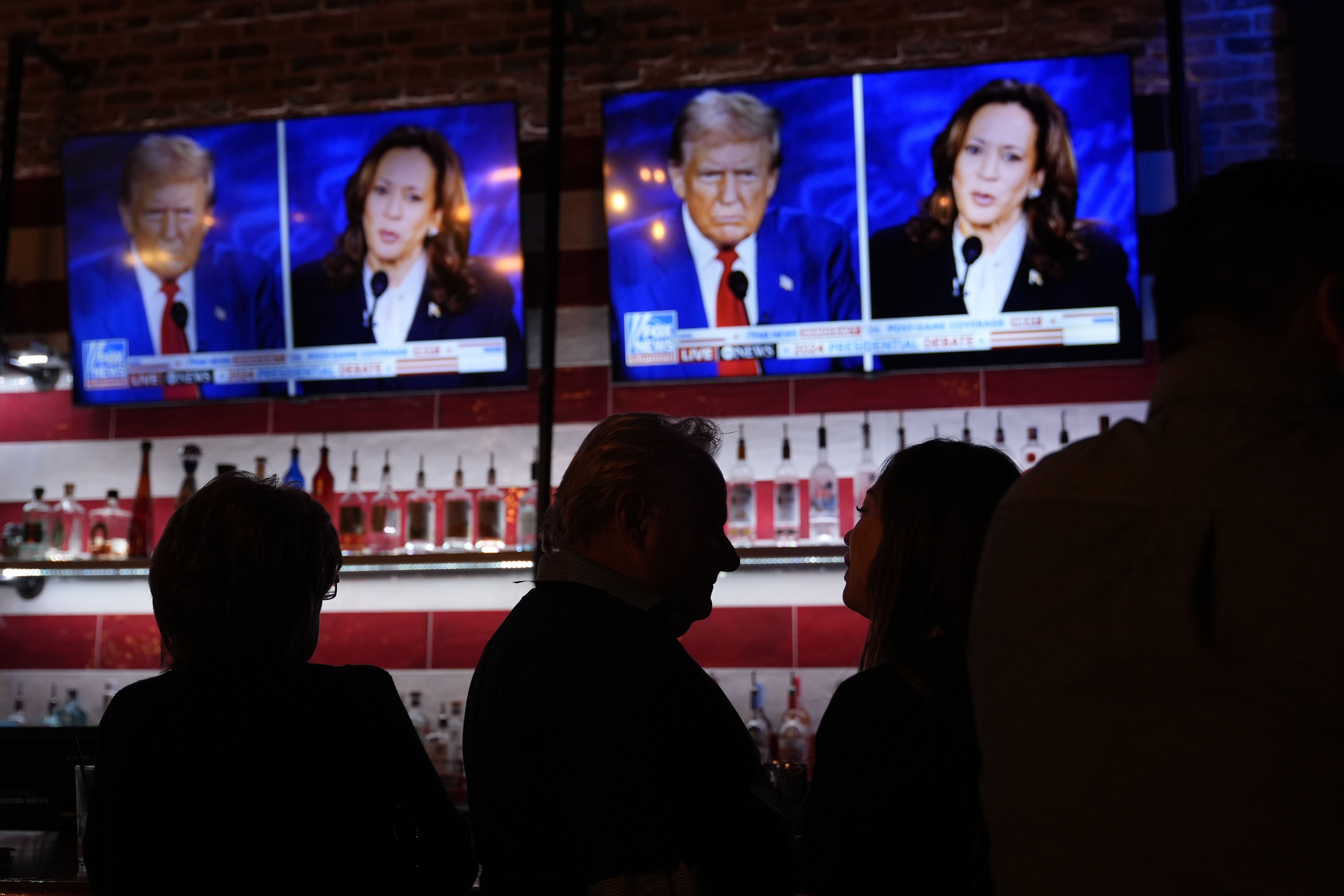 Viewers gather to watch a debate between Democratic presidential nominee Vice President Kamala Harris and Republican presidential nominee former President Donald Trump at the Angry Elephant Bar and Grill, Tuesday, in San Antonio. The Commodities and Futures Trading Commission is trying to prevent New York startup company Kalshi from resuming offering bets on the outcome of this fall's congressional elections.