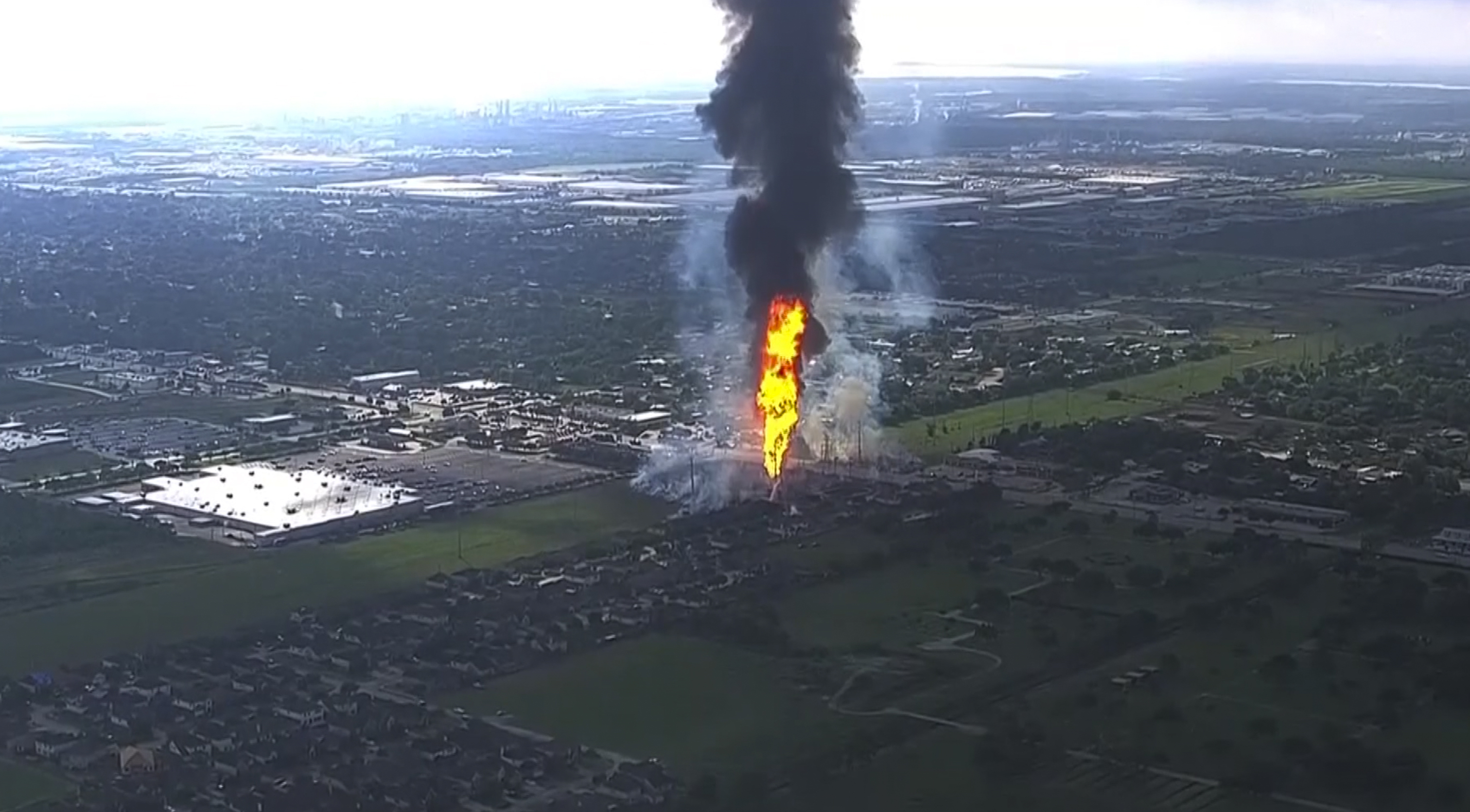 A pipeline fire in La Porte, Texas, sparks grass fires and burns power poles on Monday forcing people in the surrounding neighborhood to evacuate. 