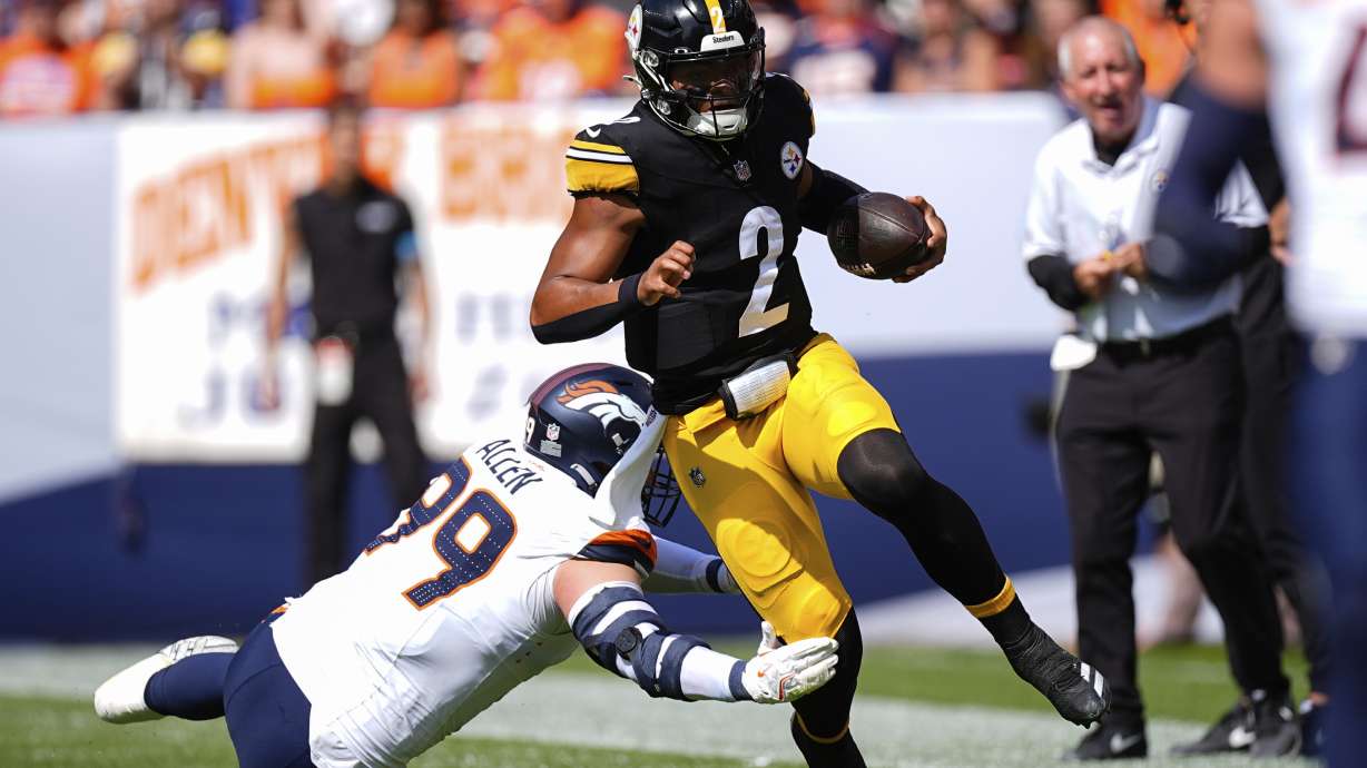 Pittsburgh Steelers quarterback Justin Fields (2) runs against Denver Broncos defensive end Zach Allen (99) during the first half of an NFL football game, Sunday, Sept. 15, 2024, in Denver.