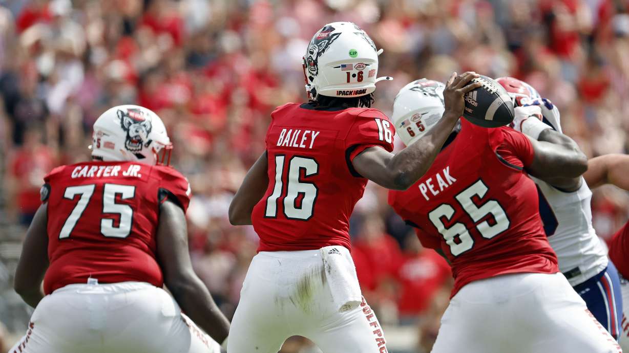 North Carolina State quarterback CJ Bailey (16) looks to throw the ball behind the protection of Anthony Carter Jr. (75) and Jacarrius Peak (65) during the second half of an NCAA college football game against Louisiana Tech in Raleigh, N.C., Saturday, Sept. 14, 2024.