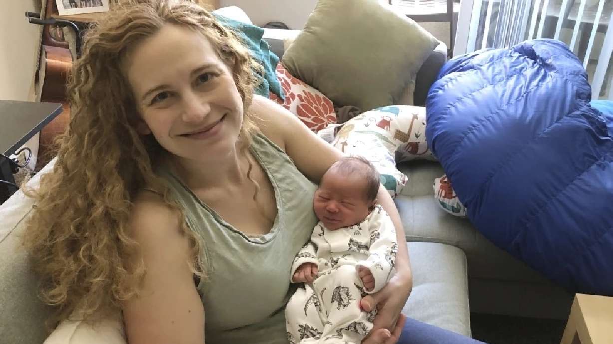 Liz Chrastil, a neuroscientist with the University of California, Irvine, holds her newborn son in May 2020. A new study reveals the brain undergoes major changes during pregnancy.