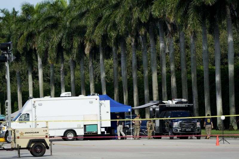 Law enforcement officials work outside of Trump International Golf Club after the apparent assassination attempt of Republican presidential nominee and former President Donald Trump Monday in West Palm Beach, Fla.