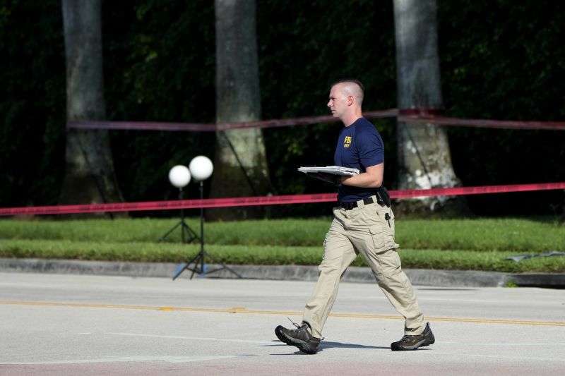 An FBI officer works outside of Trump International Golf Club after the apparent assassination attempt of Republican presidential nominee and former President Donald Trump Monday in West Palm Beach, Fla.