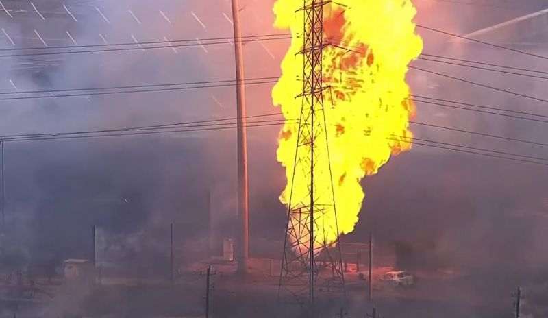 A burned vehicle sits near a pipeline fire in La Porte, Texas, Monday.