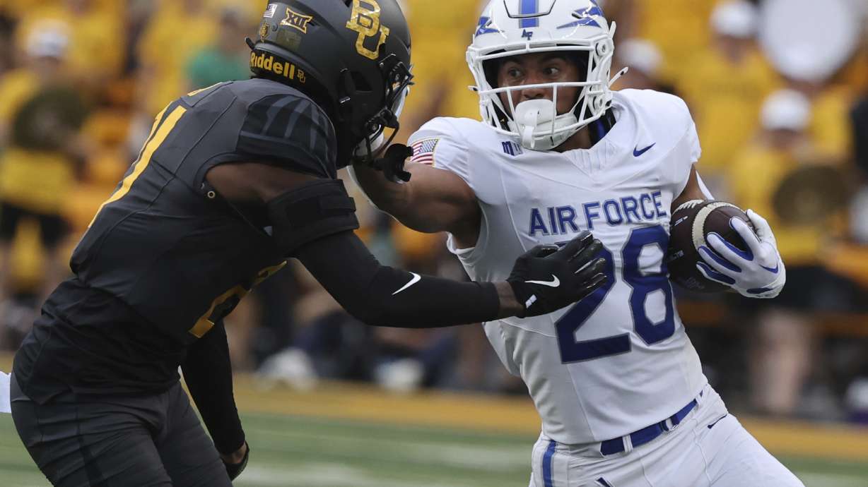 Air Force running back Aiden Calvert stiff-arms Baylor linebacker Keaton Thomas while running toward the sidelines during the first half of an NCAA college football game, Saturday, Sept. 14, 2024, in Waco, Texas.