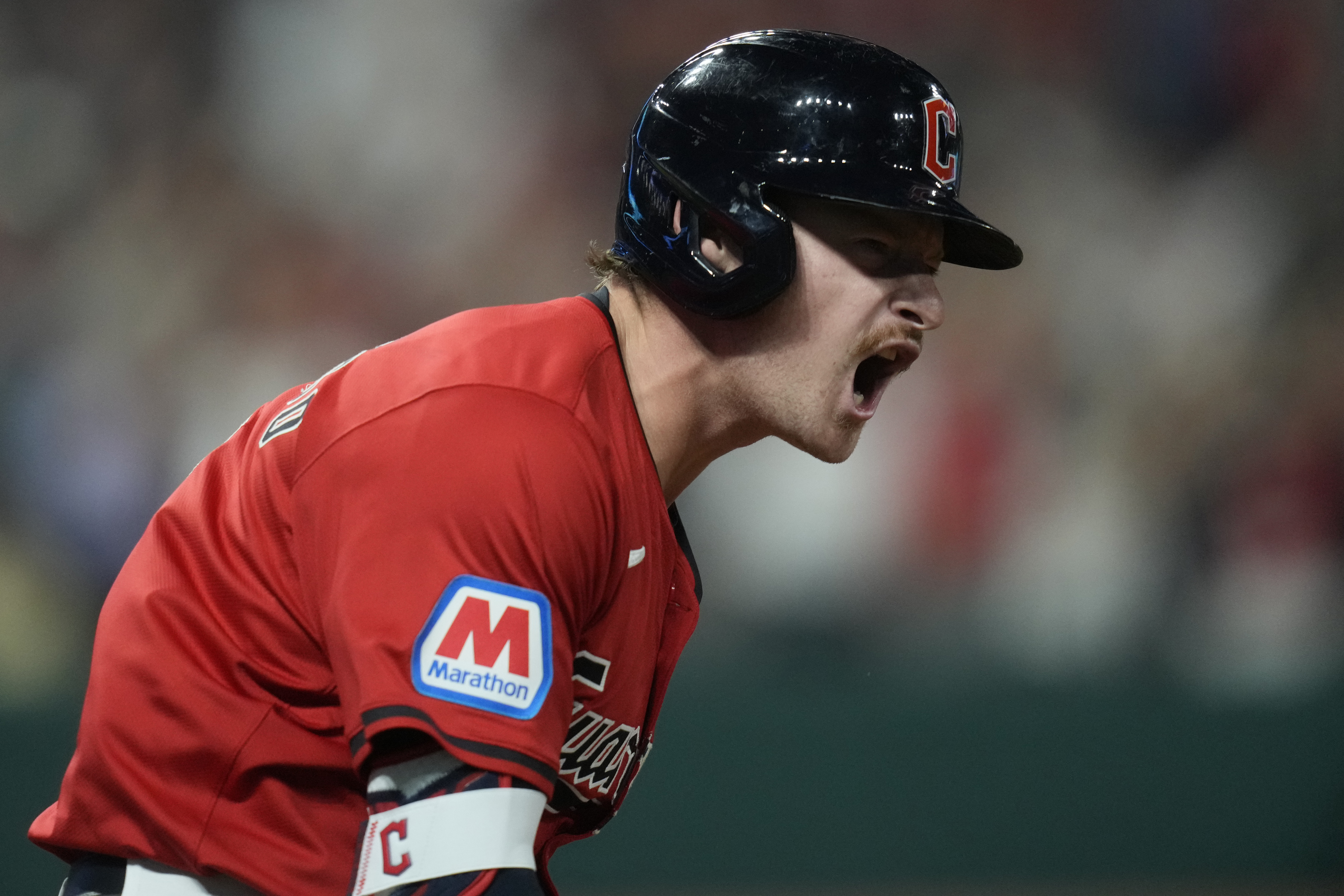 Cleveland Guardians' Kyle Manzardo reacts as he runs the bases after hitting a home run in the eighth inning of a baseball game against the Minnesota Twins, Monday, Sept. 16, 2024, in Cleveland.