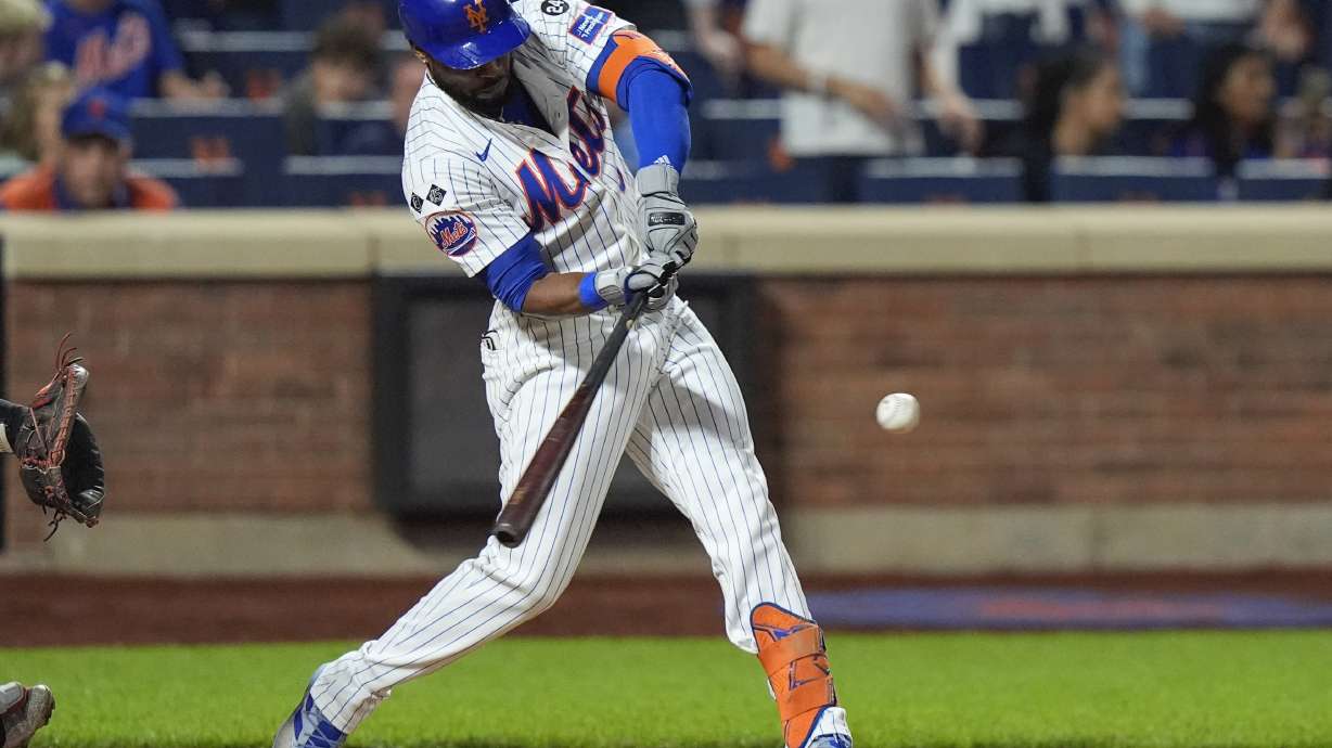 New York Mets' Starling Marte hits an RBI single during the 10th inning of a baseball game against the Washington Nationals, Monday, Sept. 16, 2024, in New York.