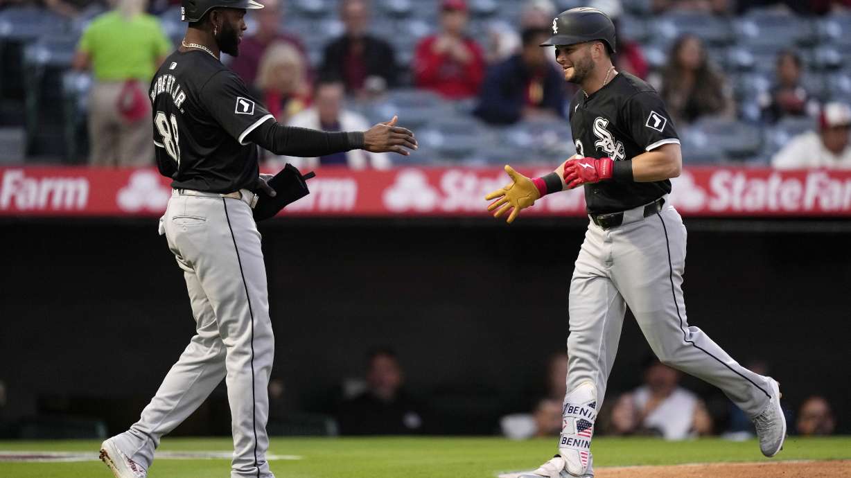 Chicago White Sox's Andrew Benintendi, right, is congratulated by Luis Robert Jr. after hitting a two-run home run during the first inning of a baseball game against the Los Angeles Angels, Monday, Sept. 16, 2024, in Anaheim, Calif.