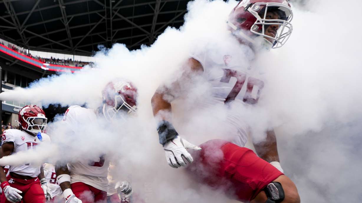 Washington State players run out onto the field before an NCAA college football game against Washington, Saturday, Sept. 14, 2024, in Seattle.