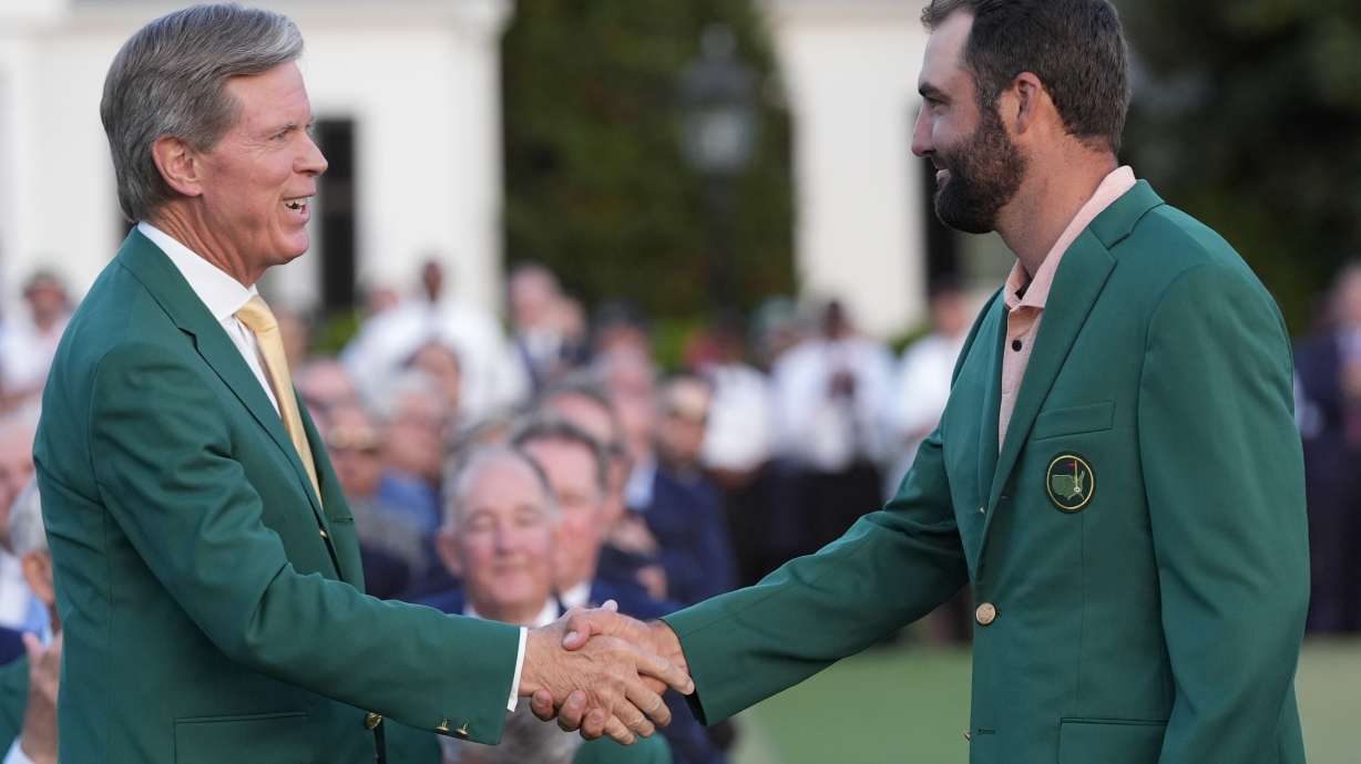 FILE - Fred Ridley, chairman of Augusta National Golf Club, shakes hands with Winner Scottie Scheffler at the Masters golf tournament at Augusta National Golf Club Sunday, April 14, 2024, in Augusta, Ga.
