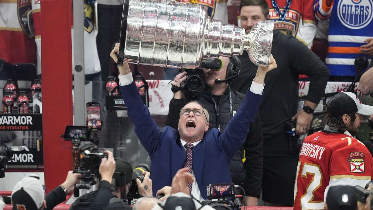 FILE - Florida Panthers head coach Paul Maurice lifts the Stanley Cup trophy after Game 7 of the NHL hockey Stanley Cup Final against the Edmonton Oilers, Monday, June 24, 2024, in Sunrise, Fla. The Panthers defeated the Oilers 2-1