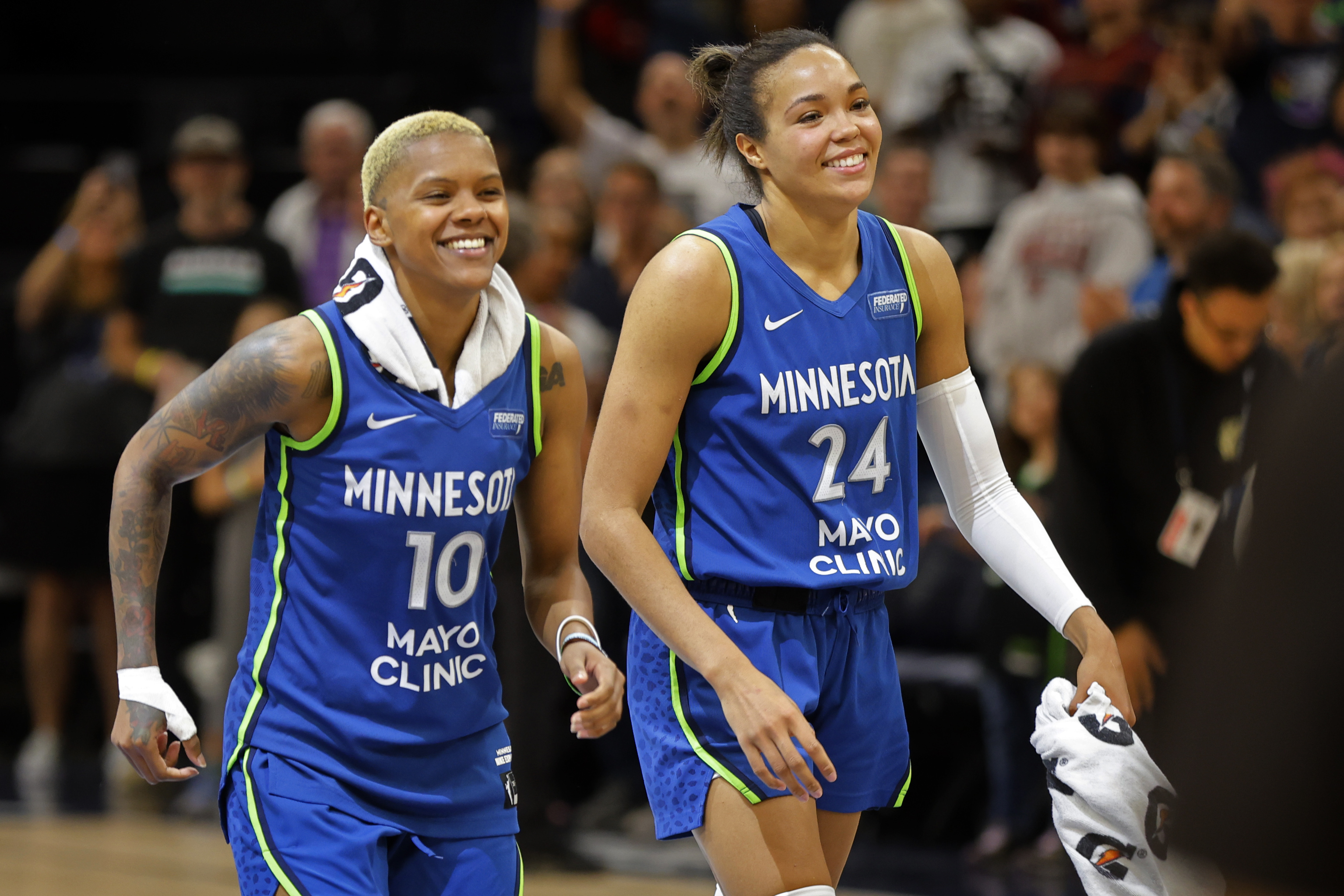 Minnesota Lynx guard Courtney Williams (10) and forward Napheesa Collier (24) celebrate after a win over the Chicago Sky in a WNBA basketball game Friday, Sept. 13, 2024, in Minneapolis.