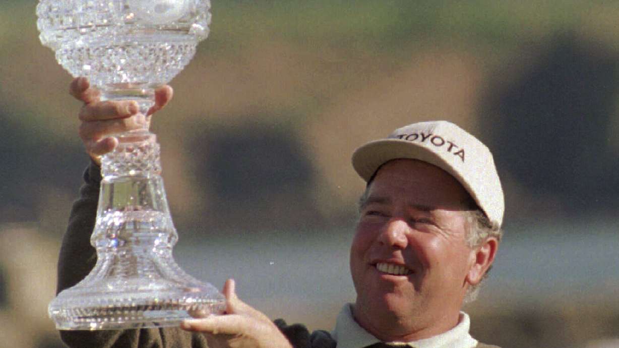 FILE - Mark O'Meara holds aloft the trophy after winning the AT&T Pebble Beach National Pro Am, Sunday, Feb. 2, 1997, at Pebble beach Golf Course.