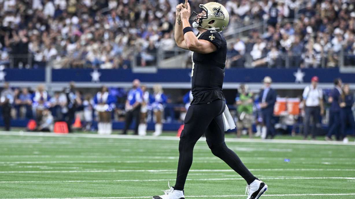 New Orleans Saints quarterback Derek Carr reacts after teammate Alvin Kamara scored a touchdown against the Dallas Cowboys during the second half of an NFL football game, Sunday, Sept. 15, 2024, in Arlington, Texas.