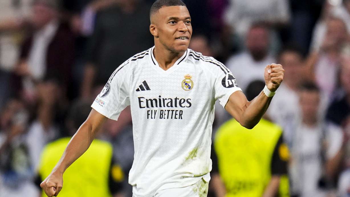 Real Madrid's Kylian Mbappe celebrates after scoring the opening goal during the Champions League opening phase soccer match between Real Madrid and VfB Stuttgart at the Santiago Bernabeu stadium, in Madrid, Tuesday, Sept. 17, 2024.