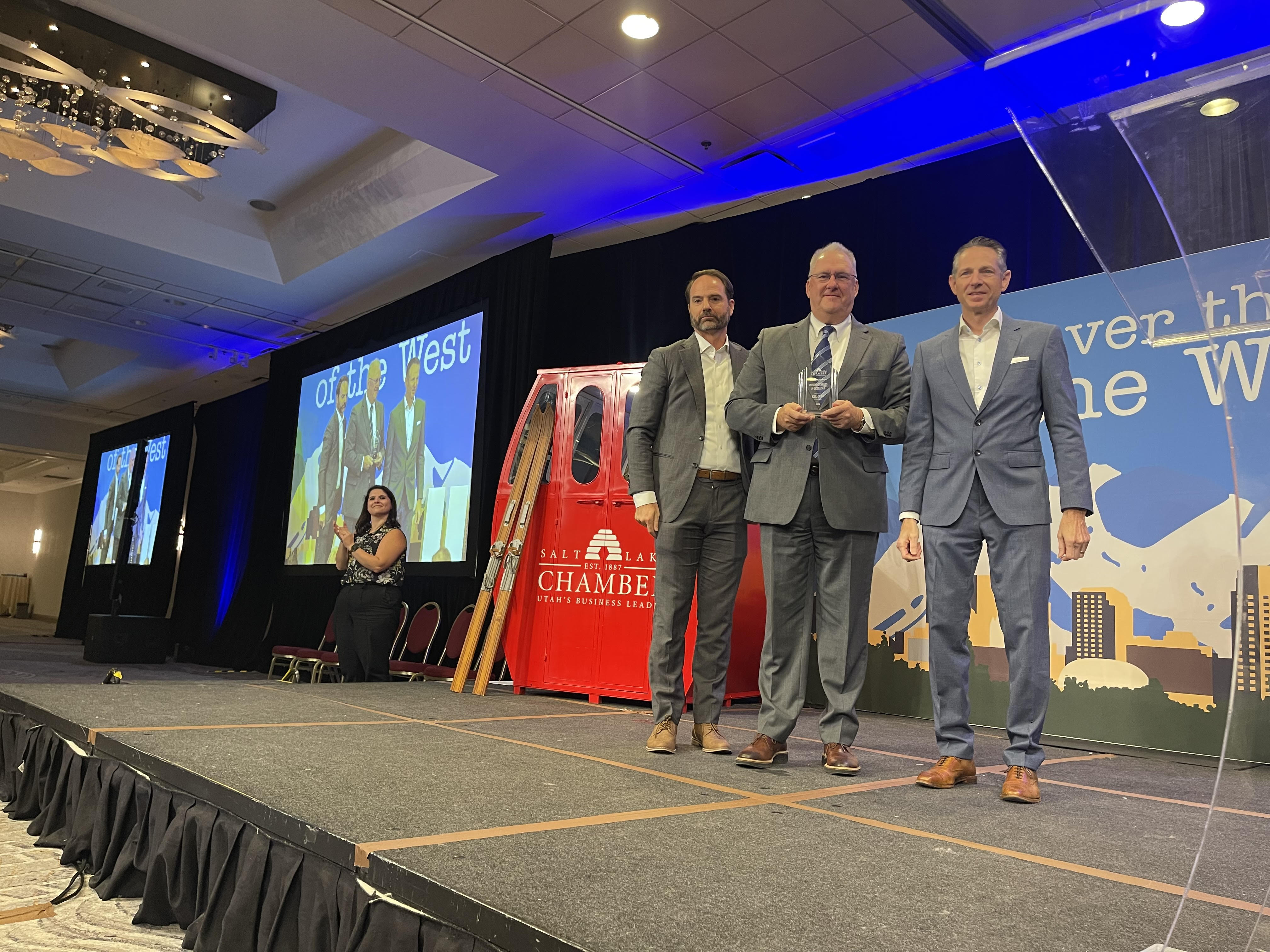 Nate Hatch, president of Deseret Digital Media, receives the President's Award in Excellence from Nathan Callister and Derek Miller during the Salt Lake Chamber's annual meeting on Tuesday.