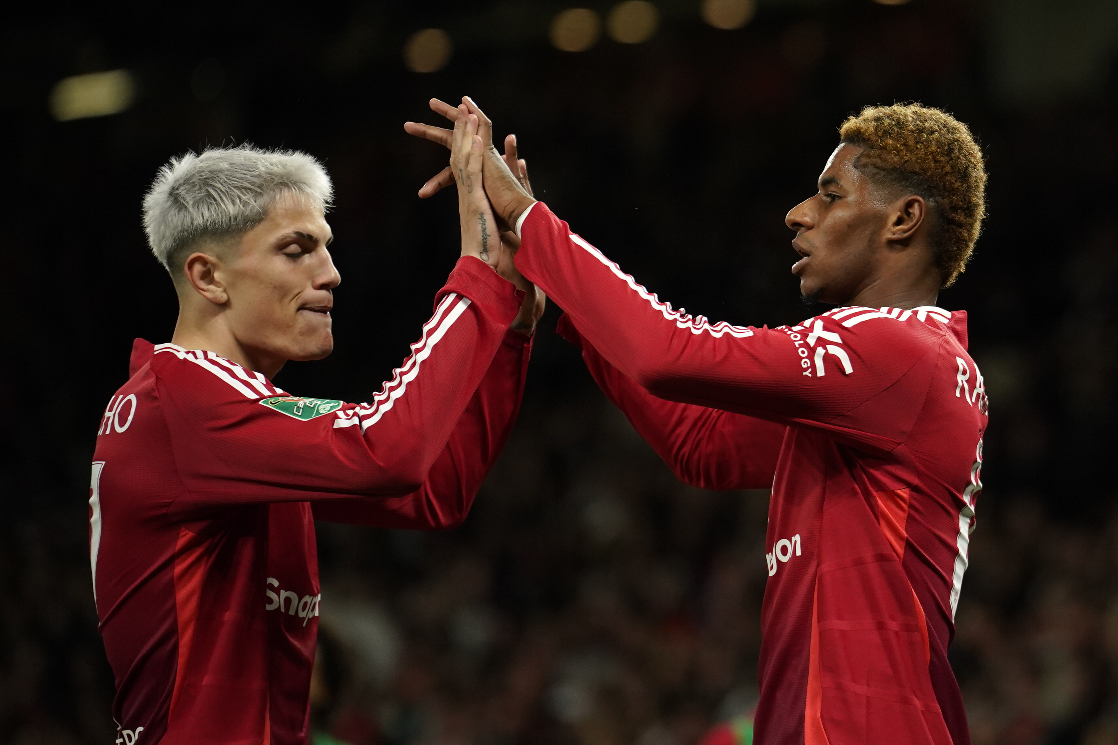 Manchester United's Marcus Rashford celebrates with Manchester United's Alejandro Garnacho, left, after scoring the fifth goal during the English League Cup soccer match between Manchester United and Barnsley at Old Trafford, Manchester, England, Tuesday, Sept. 17, 2024.