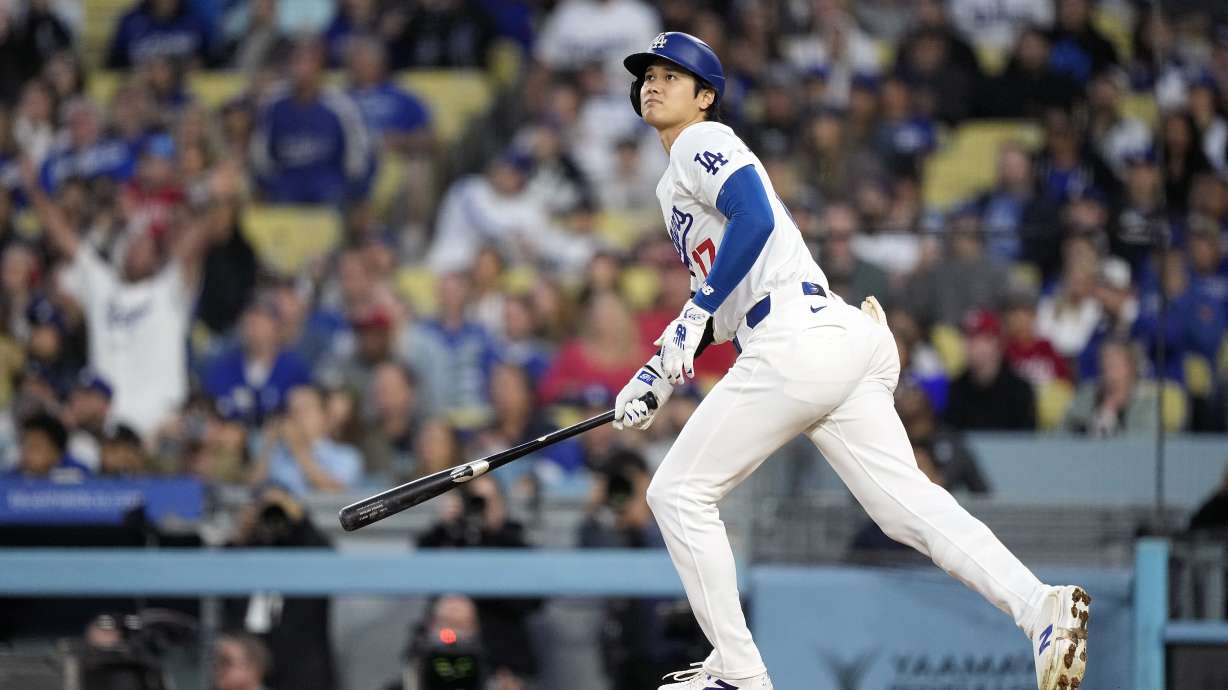 Los Angeles Dodgers designated hitter Shohei Ohtani heads to first after hitting a two-run home run during the third inning of a baseball game against the Cincinnati Reds Friday, May 17, 2024, in Los Angeles.