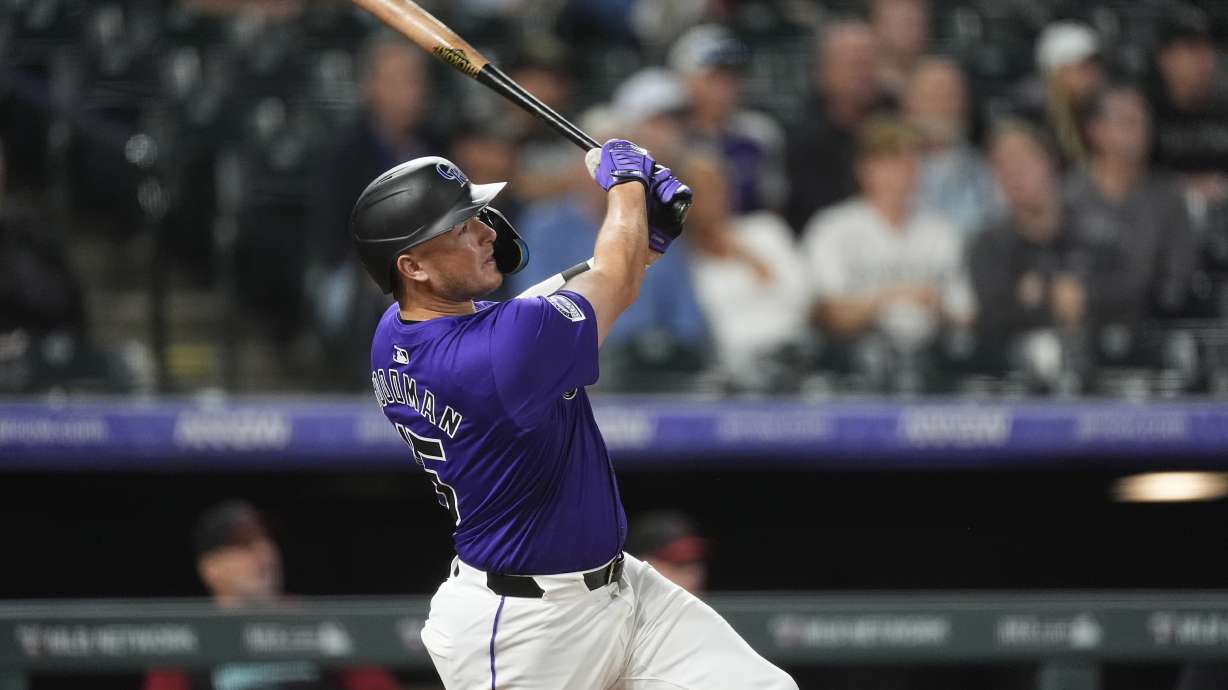 Colorado Rockies' Hunter Goodman follows the flight of his solo home run off Arizona Diamondbacks relief pitcher Blake Walston in the seventh inning of a baseball game Tuesday, Sept. 17, 2024, in Denver.