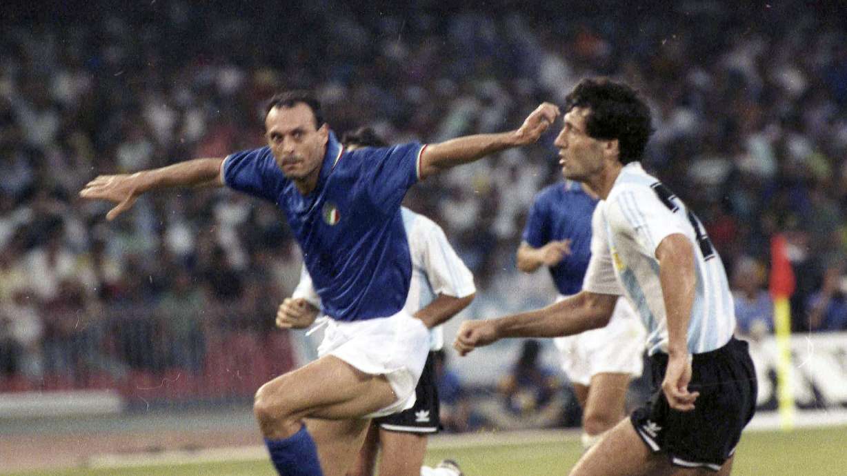 FILE - Italy's Salvatore "Totò" Schillaci, left, and Argentina's Juan Simon chase the ball during the Soccer World Cup semi-final, in Naples, Italy, July 3, 1990.