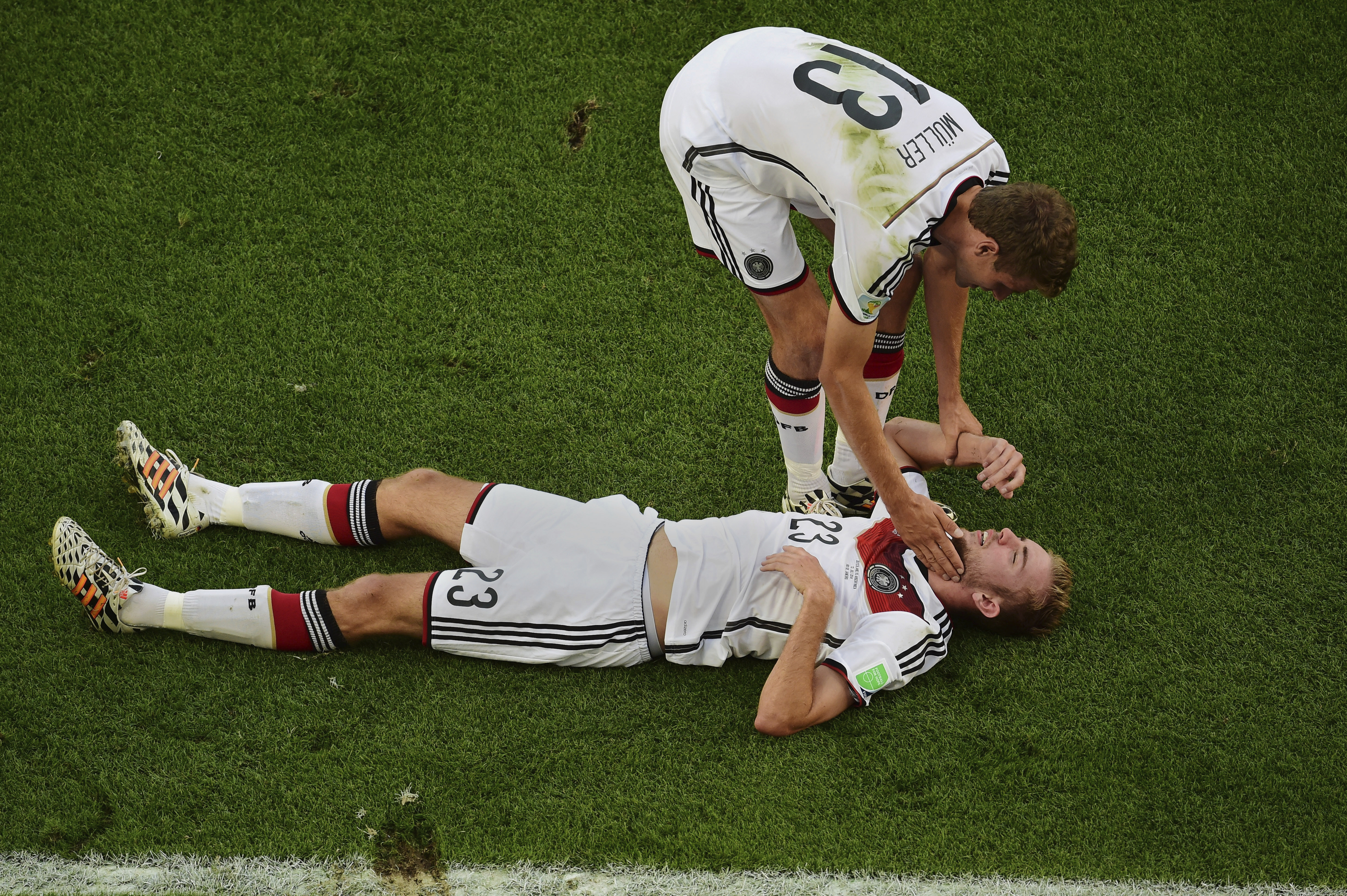 FILE - Germany's Christoph Kramer lies on the pitch as teammate Thomas Mueller assists him, during the World Cup final soccer match between Germany and Argentina at the Maracana Stadium in Rio de Janeiro, Brazil, on July 13, 2014.