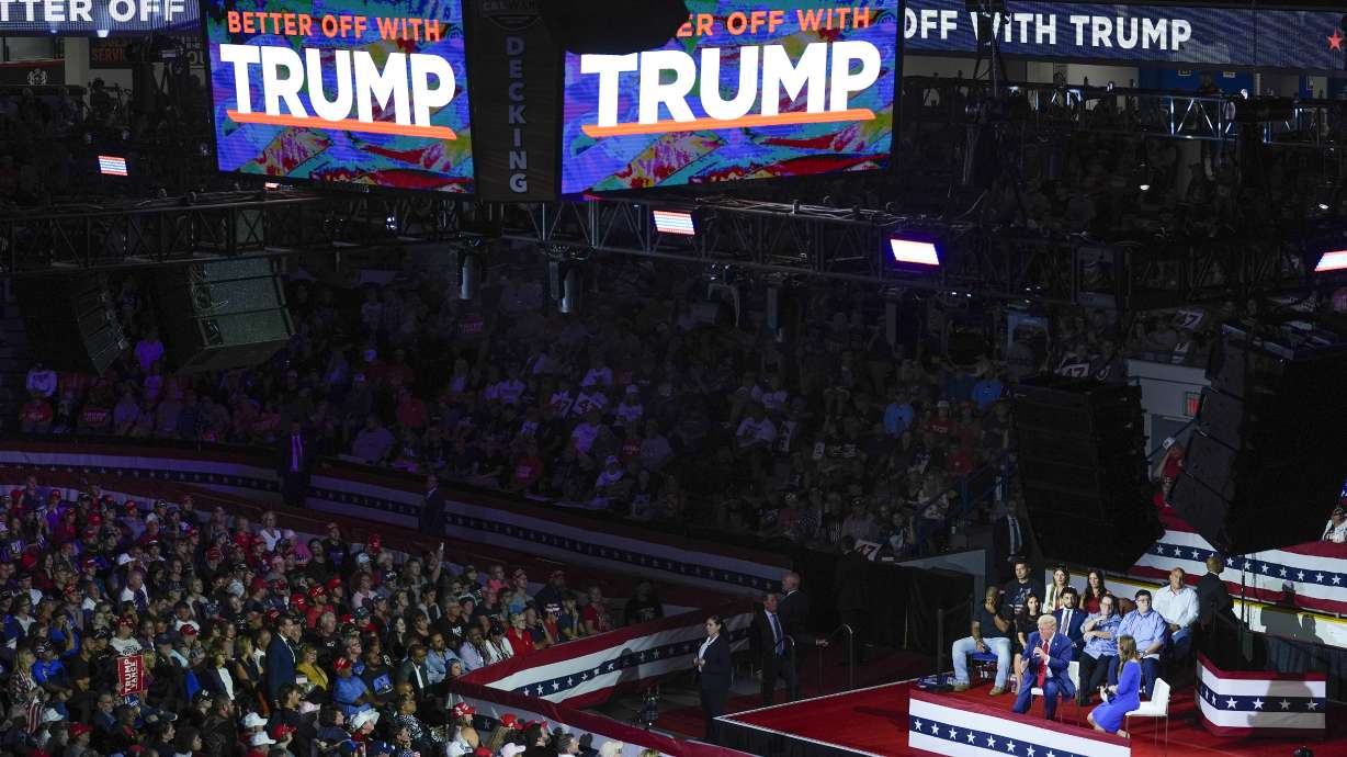 Republican presidential candidate former President Donald Trump on stage with Arkansas Gov. Sarah Huckabee Sanders during a town hall event at the Dort Financial Center in Flint, Mich., on Tuesday. The presidential candidates are taking a brief break from campaigning in battleground states on Wednesday.
