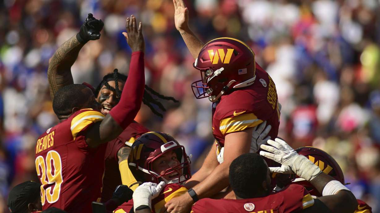Washington Commanders place kicker Austin Seibert, top right, celebrates with teammate after kicking the game-winning field goal against the New York Giants during the second half of an NFL football game in Landover, Md., Sunday, Sept. 15, 2024.