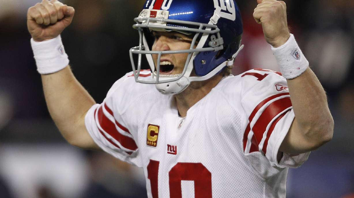 FILE - New York Giants quarterback Eli Manning celebrates his touchdown pass to tight end Jake Ballard in the last minute of an NFL football game against the New England Patriots in Foxborough, Mass., Sunday, Nov. 6, 2011.