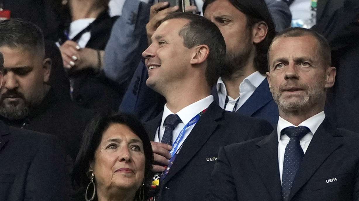 FILE - UEFA's deputy general secretary Kevin Lamour, centre, looks on as he stands next to UEFA President Aleksander Ceferin, right, prior to the start of a Group F match between Turkey and Georgia at the Euro 2024 soccer tournament in Dortmund, Germany, Tuesday, June 18, 2024. Kevin Lamour will join FIFA as chief operating officer on Nov. 1, soccer's world body told staff on Wednesday, Sept, 18, 2024, in an email seen by The Associated Press.