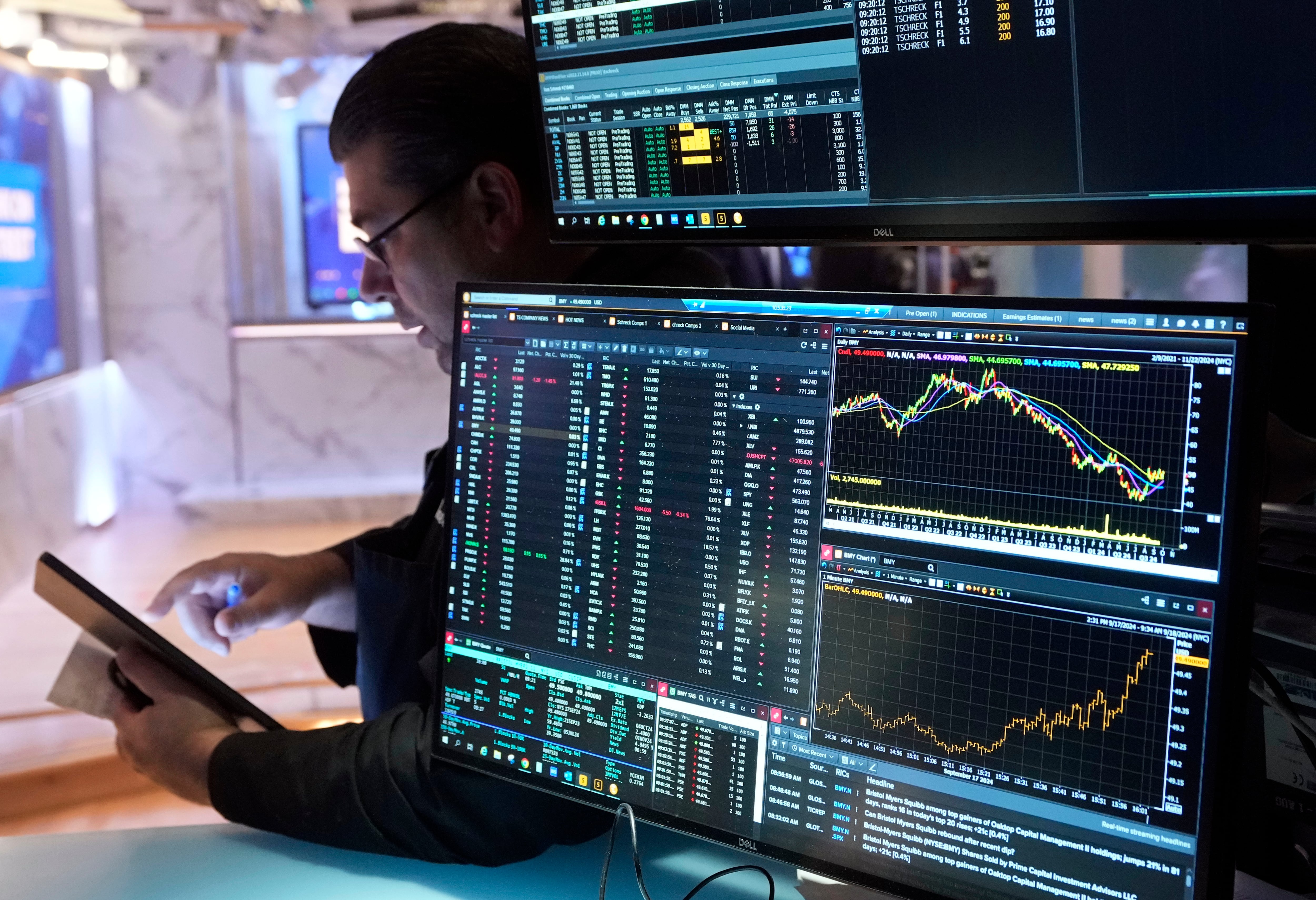 Trader Michael Capolino works on the floor of the New York Stock Exchange, Wednesday. The U.S. Federal Reserve made a cut to its benchmark federal funds rate on Wednesday 