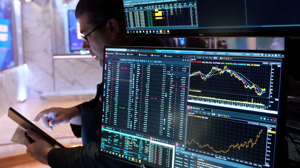 Trader Michael Capolino works on the floor of the New York Stock Exchange, Wednesday. The U.S. Federal Reserve made a cut to its benchmark federal funds rate on Wednesday