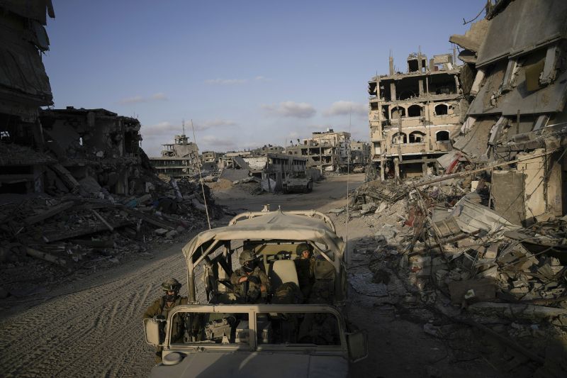 Israeli soldiers move next to destroyed buildings following Israeli strikes during a ground operation in the Gaza Strip, Sept. 13.