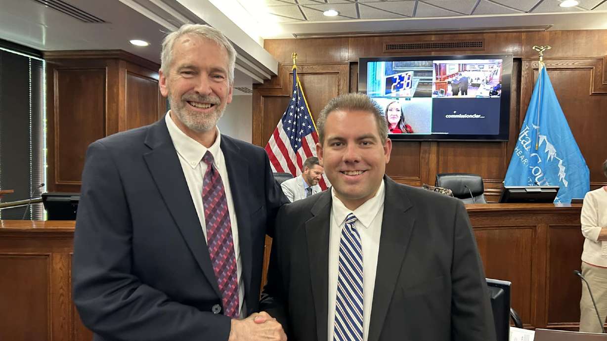 Skyler Beltran shakes hands with County Clerk Aaron Davidson after being sworn in Wednesday to the Utah County Commission to fill the vacancy left by Tom Sakievich who resigned over health issues.