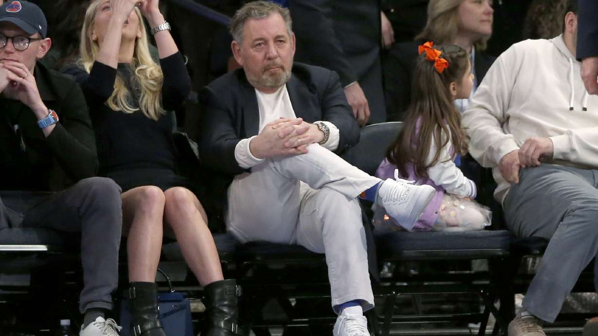 FILE - New York Knicks owner James Dolan, center, watches the second half of an NBA basketball game against the Chicago Bulls, April 14, 2024, in New York.