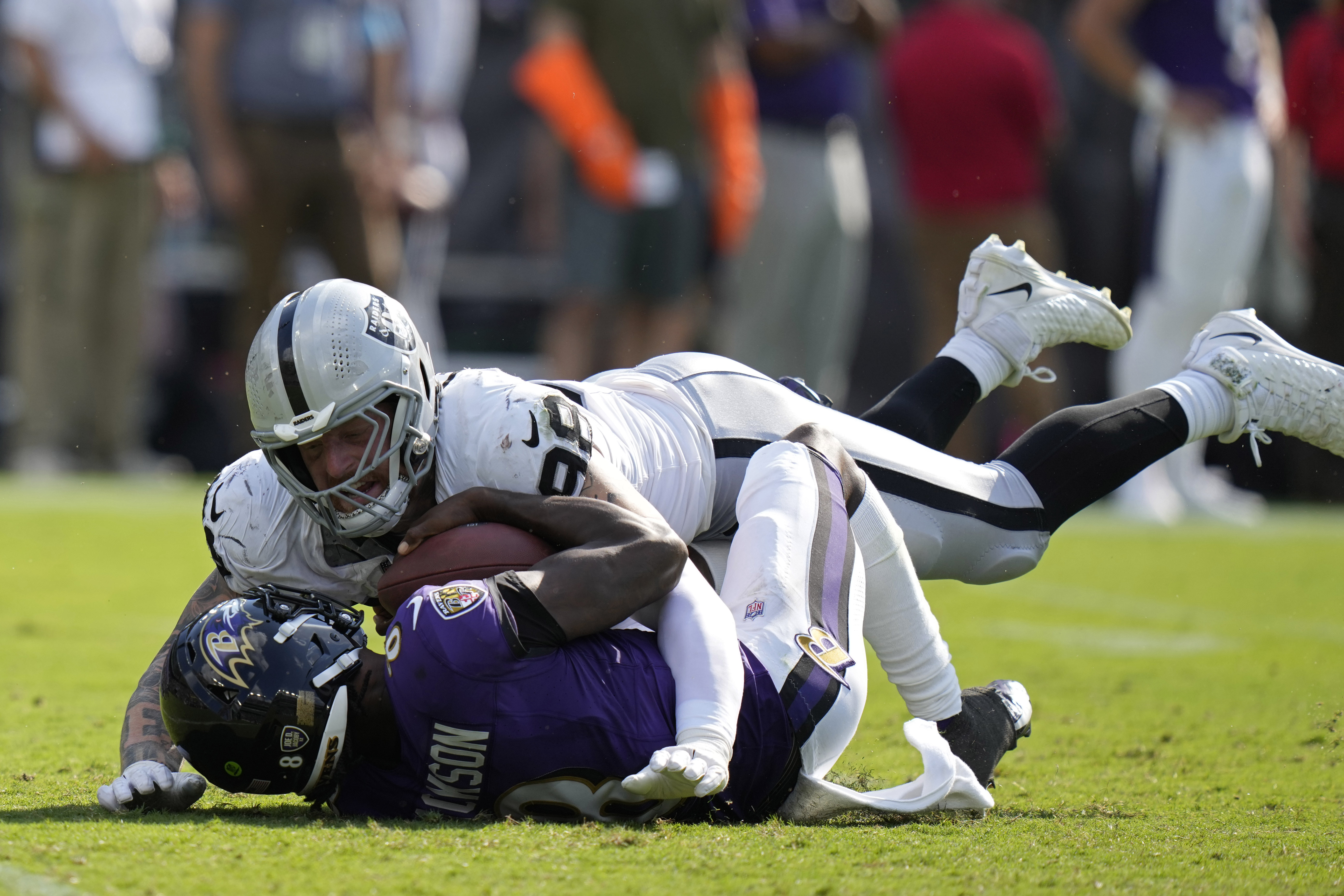 Las Vegas Raiders defensive end Maxx Crosby (98) sacks Baltimore Ravens quarterback Lamar Jackson (8) during the second half of an NFL football game, Sunday, Sept. 15, 2024, in Baltimore.