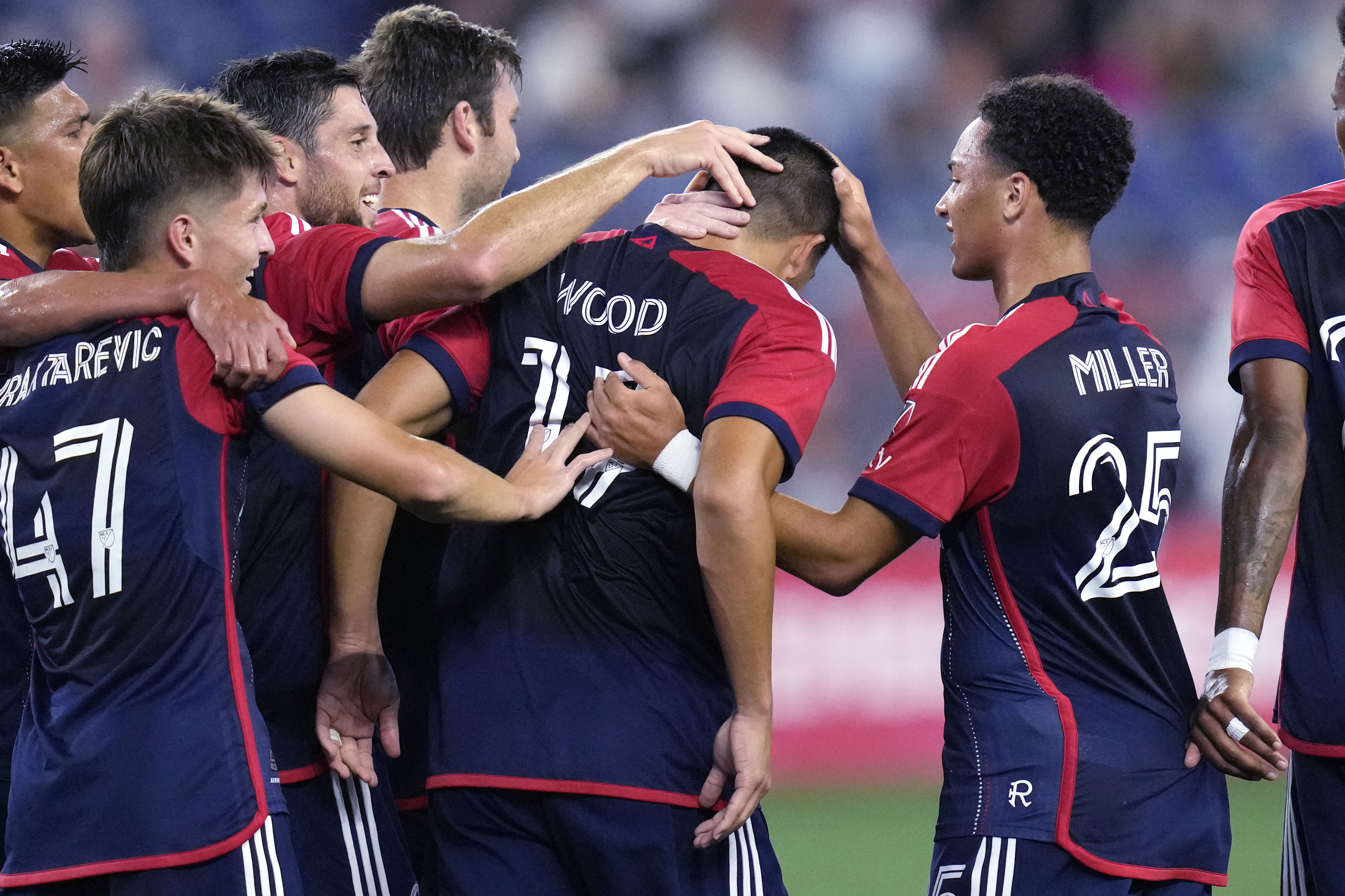 New England Revolution forward Bobby Wood is congratulated after his goal against CF Montréal during the first half of an MLS soccer game, Wednesday, Sept. 18, 2024, in Foxborough, Mass.