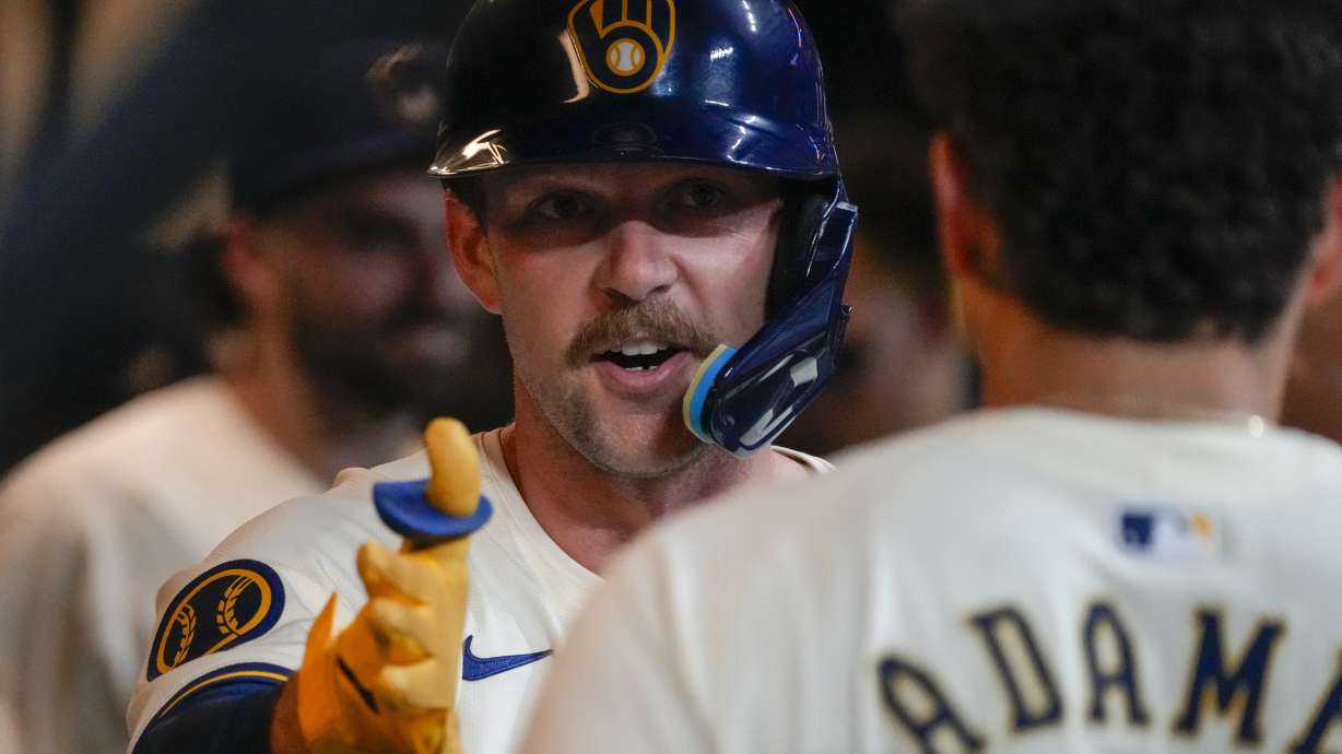 Milwaukee Brewers' Rhys Hoskins is congratulated after hitting a home run during the fifth inning of a baseball game against the Philadelphia Phillies Wednesday, Sept. 18, 2024, in Milwaukee.