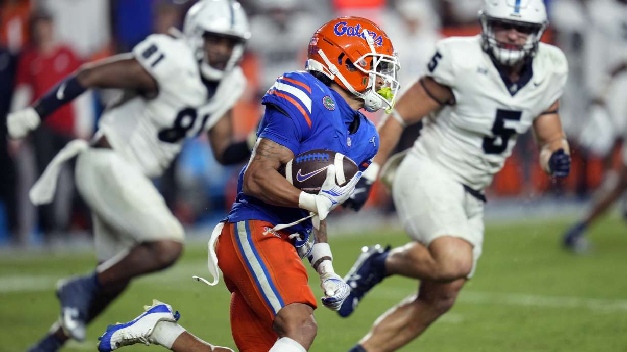 Florida wide receiver Eugene Wilson III, center, runs for an 85-yard touchdown off a pass play past Samford defensive lineman Jamall Thompson (81) and linebacker Noah Martin (5) during the second half of an NCAA college football game, Saturday, Sept. 7, 2024, in Gainesville, Fla.